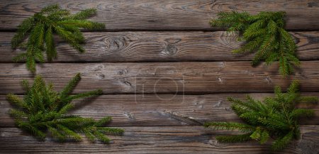 Photo for Fir branch on old dark wooden background - Royalty Free Image