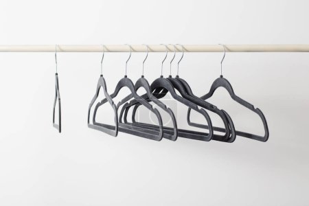 Photo for Gray empty hangers on railing white background - Royalty Free Image