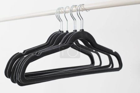 Photo for Gray empty hangers on railing white background - Royalty Free Image