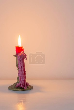 Photo for Red burning candle in white interior - Royalty Free Image