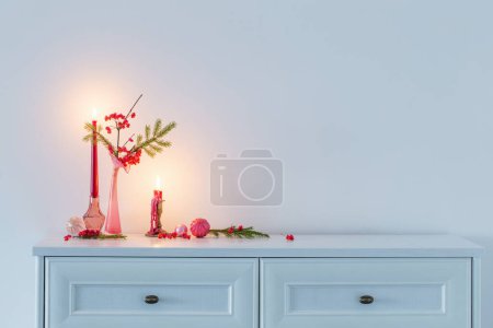 Photo for Pink christmas decor with burning candles in white interior - Royalty Free Image