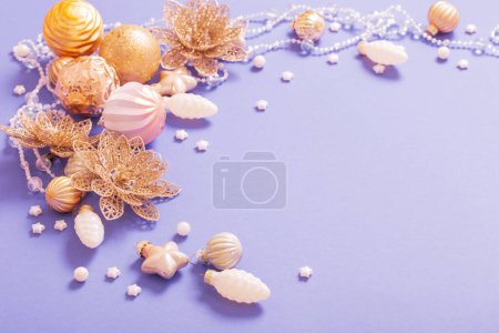 Photo for Golden christmas toys on purple  background - Royalty Free Image
