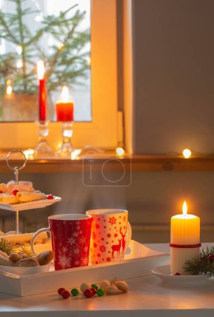 Photo for Christmas decor and red cups with hot drink on kitchen - Royalty Free Image