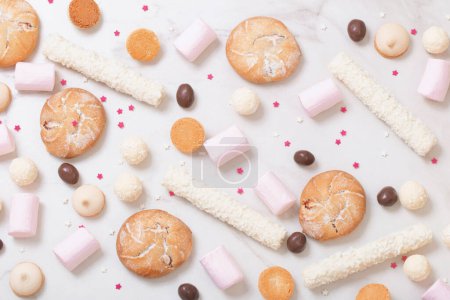 Photo for Candies and cookies  on white marble background - Royalty Free Image