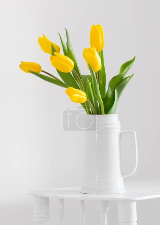 Photo for Yellow tulips in vase on white background - Royalty Free Image