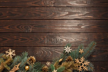 Photo for Fir branches with Christmas decor on old dark wooden background - Royalty Free Image