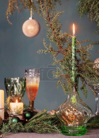 Photo for Green and golden christmas decor on table on dark background - Royalty Free Image