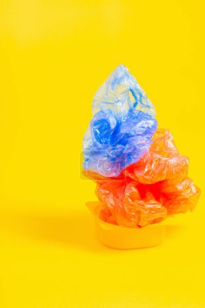 Photo for Plastic trash on bright yellow background - Royalty Free Image