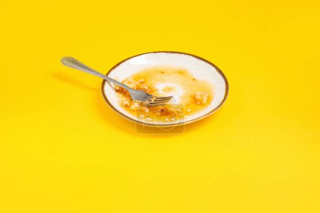 Photo for Dirty plate with honey and pie crumbs on yellow background - Royalty Free Image