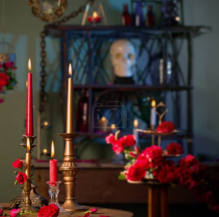 Foto de Poción mágica con rosas rojas y velas encendidas en la habitación oscura - Imagen libre de derechos