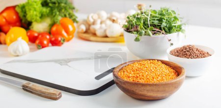 Foto de Comida vegetariana sana y fresca en la mesa blanca en la cocina - Imagen libre de derechos