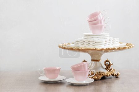 Téléchargez les photos : Plats pour servir le thé sur une table en bois sur fond blanc - en image libre de droit