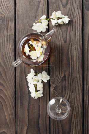 Photo for Jasmine tea on dark wooden table - Royalty Free Image