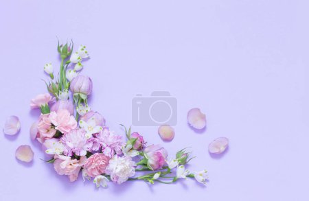 Photo for Beautiful spring flowers on purple background - Royalty Free Image