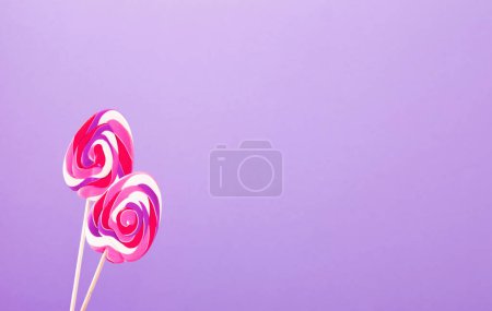 Photo for Easter candy canes in  form of eggs on purple background - Royalty Free Image