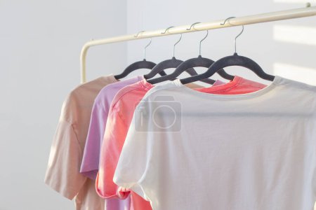 Photo for Women's t-shirts on  hanger on  white background - Royalty Free Image