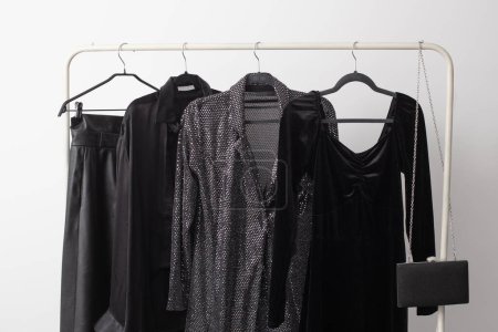 Photo for Elegant black evening wear on a hanger - Royalty Free Image