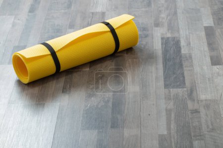 Photo for Fitness mat on wooden floor at home - Royalty Free Image