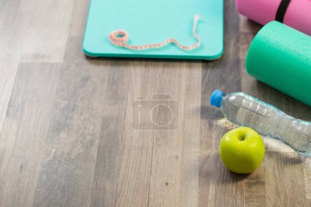 Photo for Fitness mat on wooden floor, concept of health and sport - Royalty Free Image