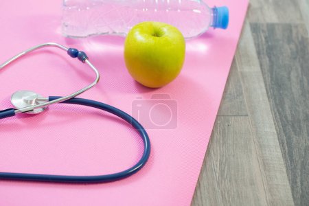 Photo for Stethoscope on fitness mat, heart health concept - Royalty Free Image