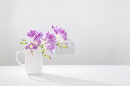 Photo for Purple freesia in glass vase on white background - Royalty Free Image