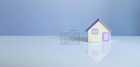 Photo for Little paper house on blue background - Royalty Free Image