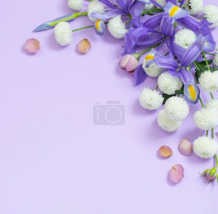 Beautiful flowers on purple paper background