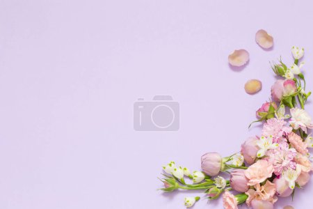 Photo for Beautiful spring flowers on purple background - Royalty Free Image