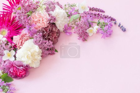 Photo for Beautiful summer flowers on pink paper background - Royalty Free Image