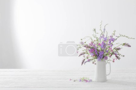 Photo for Summer wild  flowers  in white jug on white background - Royalty Free Image