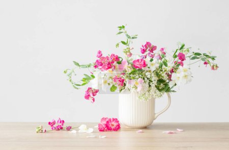 Photo for Summer flowers in ceramic cup on light background - Royalty Free Image