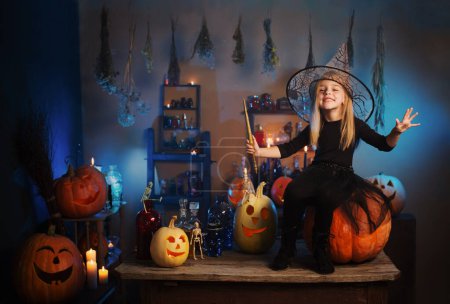 Téléchargez les photos : Belle petite sorcière aux décorations d'Halloween - en image libre de droit
