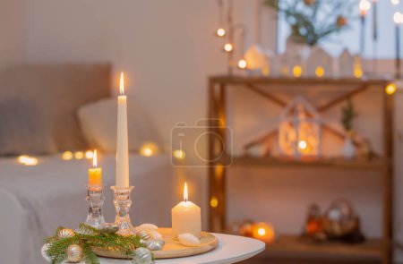 beautiful white room with christmas decor with burning candles