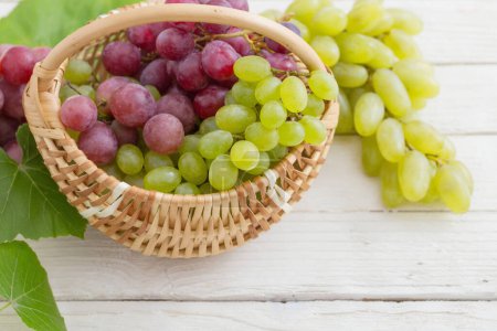 Photo for Pink and green grape on wooden background - Royalty Free Image