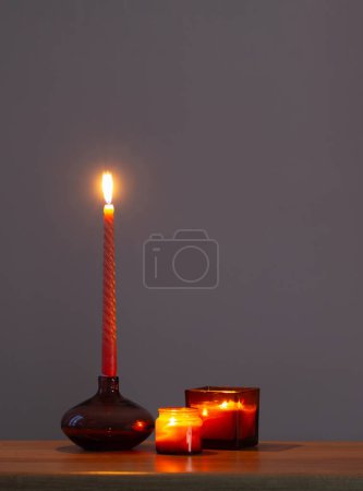 Photo for Burning candles in glass candlesticks on dark background - Royalty Free Image