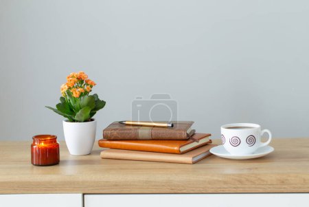 Photo for Still life with house plant, notepad, pen and coffee cup in modern interior - Royalty Free Image