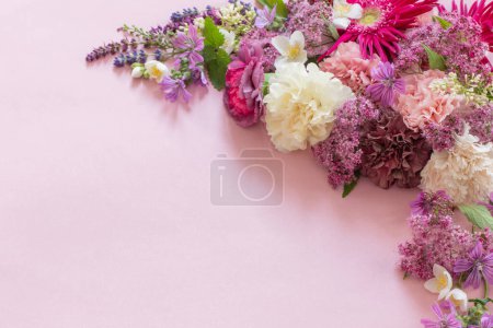 Photo for Beautiful summer flowers on pink paper background - Royalty Free Image