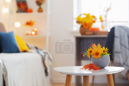Photo for Beautiful autumnal bouquet with flowers and leaves at home - Royalty Free Image
