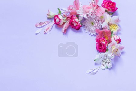Photo for Alstroemeriaand chrysanthemums  flowers on violet  background - Royalty Free Image