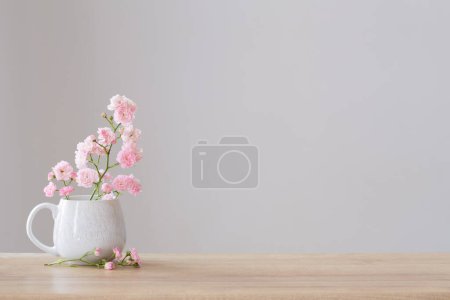 Photo for Pink poses in ceramic cup on white background - Royalty Free Image