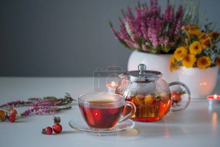 Photo for Rosehip tea on white table in kitchen - Royalty Free Image