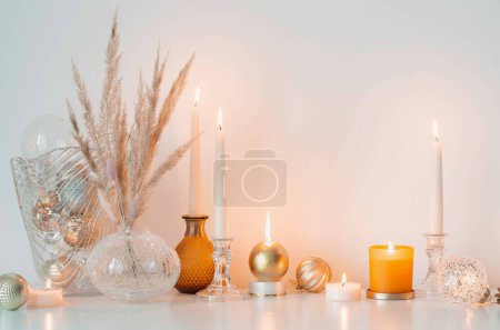 Photo for Christmas decorations with burning candles in white room - Royalty Free Image
