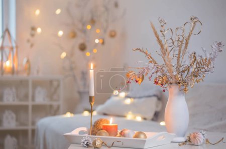 Photo for Christmas home decorations with candles in white interior - Royalty Free Image