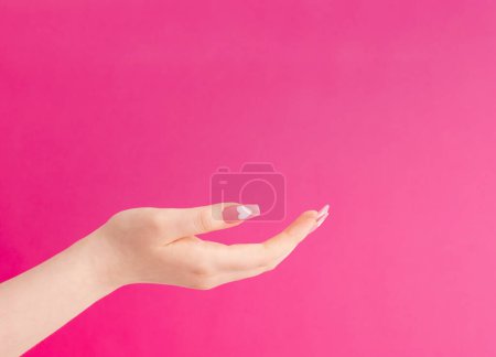 Photo for Female hands with beautiful long nails with  manicure with  heart pattern on pink background - Royalty Free Image