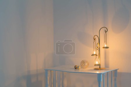 Photo for Golden candlestick with burning candles and christmas decorations on wooden shelf - Royalty Free Image