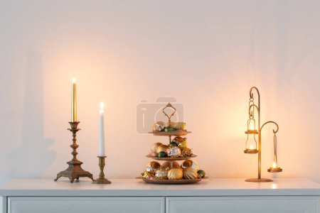Photo for Christmas golden decor with burning candles in white interior - Royalty Free Image