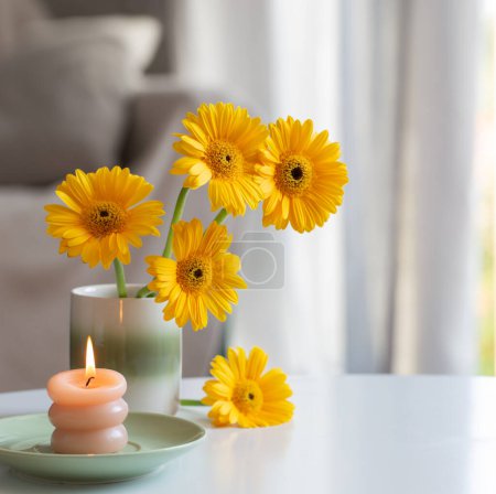 Photo for Yellow gerbera in ceramic vase in light living room - Royalty Free Image