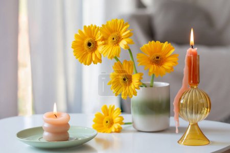 Foto de Gerberas amarillas en jarrón de cerámica en sala de estar ligera - Imagen libre de derechos