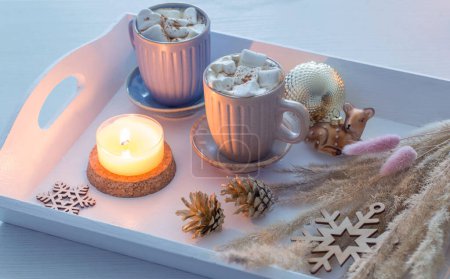Téléchargez les photos : Deux tasses de boisson chaude avec guimauves et décor de Noël sur plateau en bois blanc - en image libre de droit