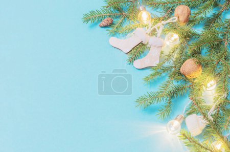 Téléchargez les photos : Décorations de Noël en bois avec des lumières sur fond de papier bleu - en image libre de droit